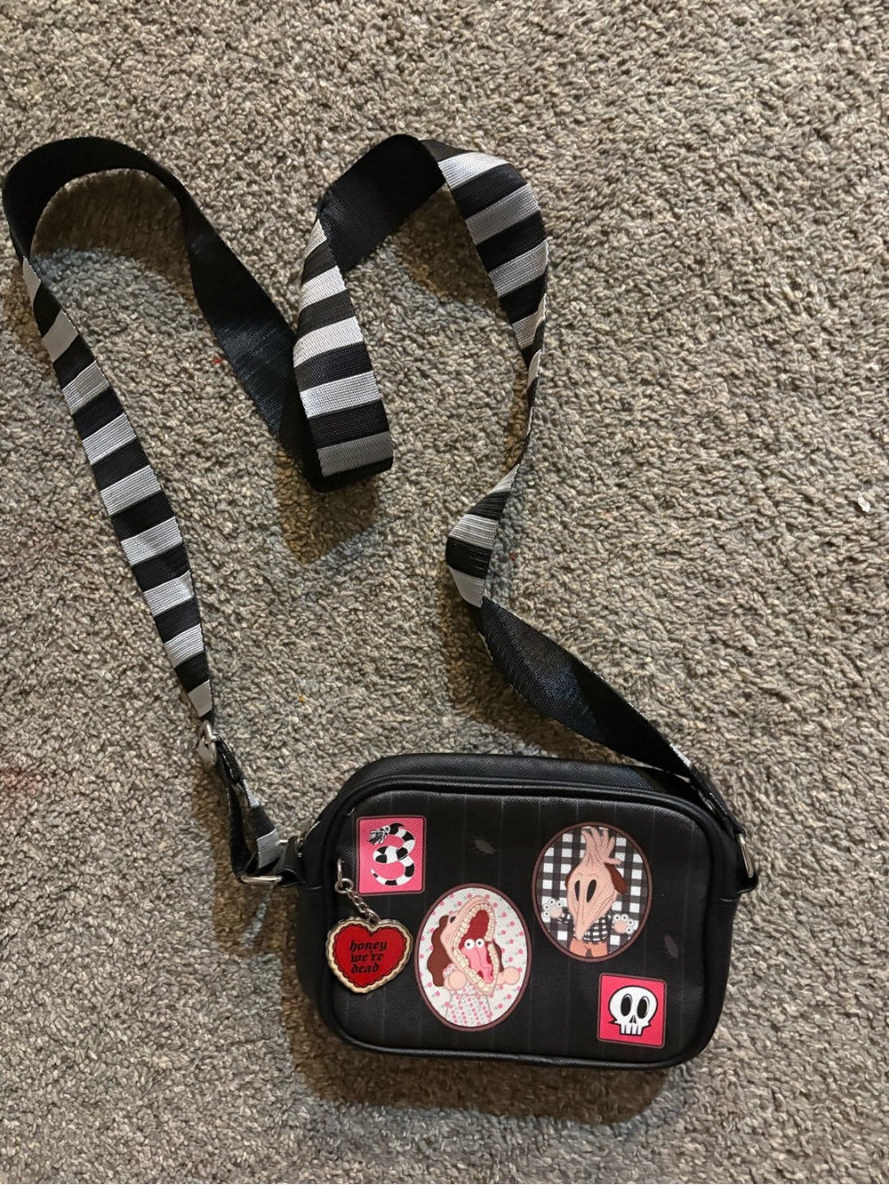 Beetlejuice Black Crossbody Bag with Striped Strap and Patch Accents